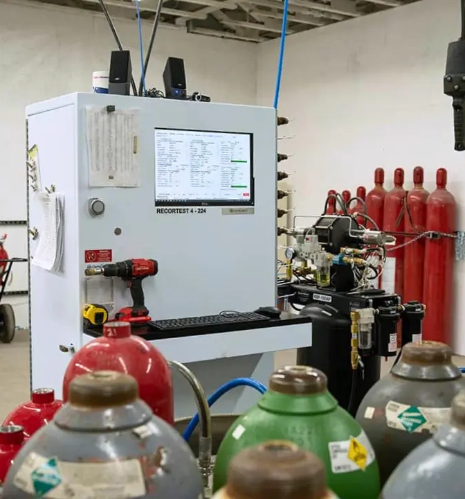 Hydrostatic testing of fire suppression system cylinders performed by State Fire technicians to verify pressure integrity, safety, and compliance standards.